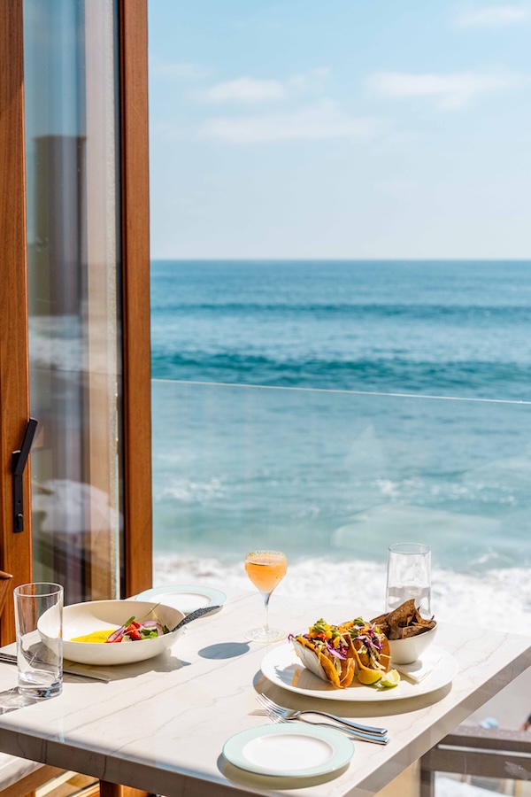 a table with food on it and a glass of wine on it