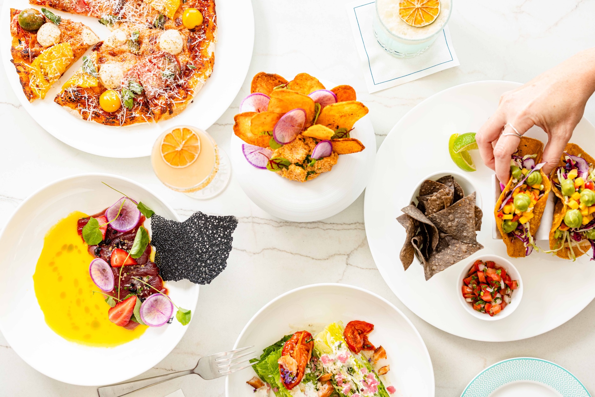 a table with plates of food and drinks