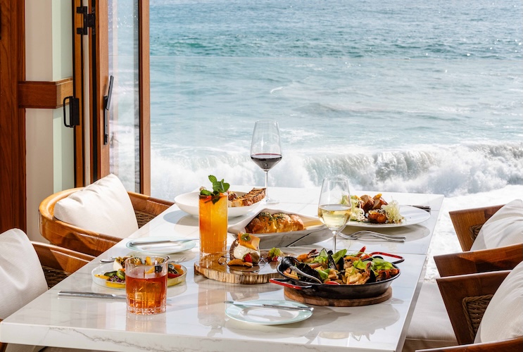 a table with food on it and a glass of wine on it