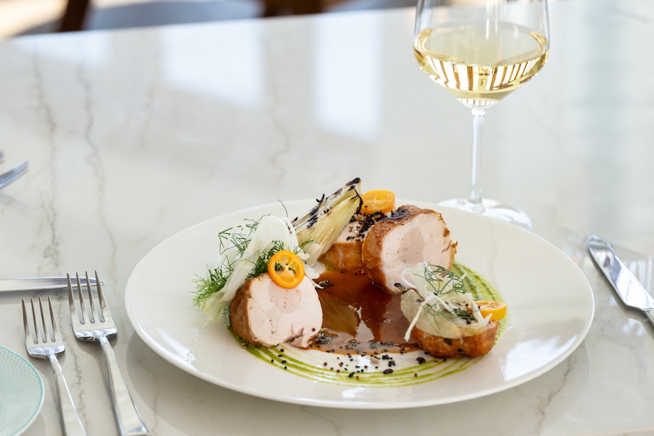 a plate of food and a glass of wine