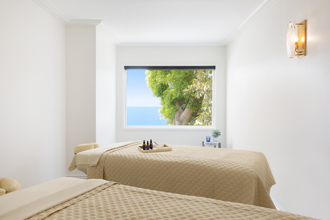 a room with two beds and a window