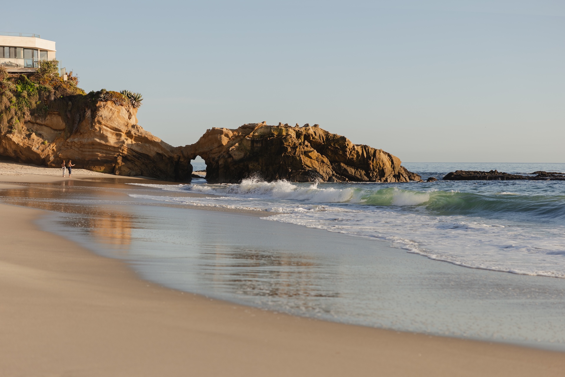 a beach with waves crashing on the shore