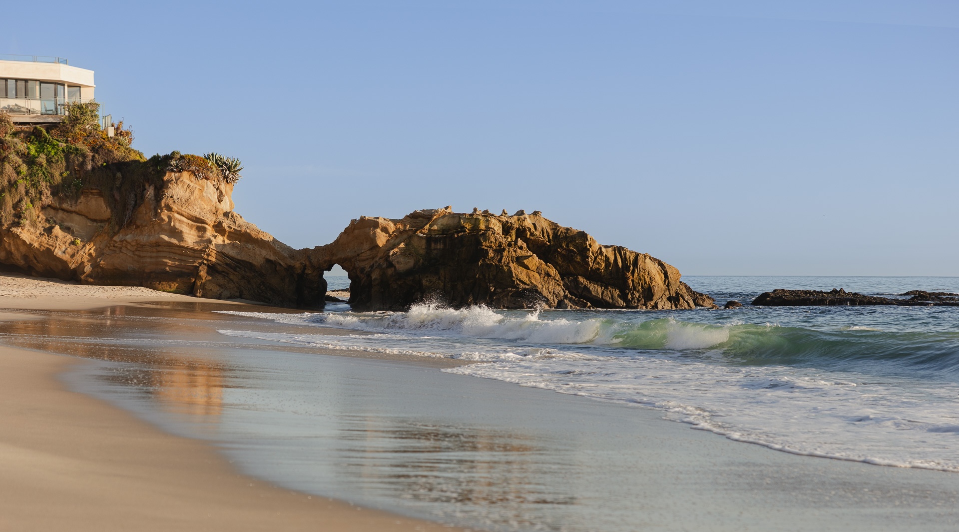 a beach with waves crashing on the shore
