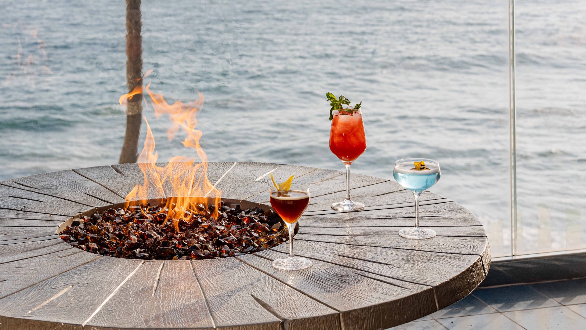 a fire pit with drinks on a table