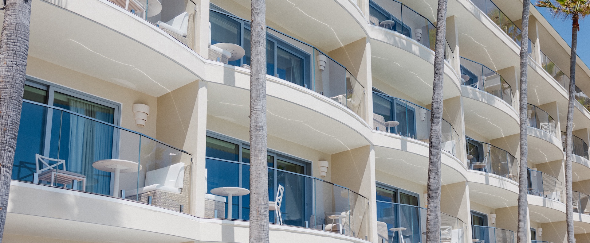 a building with balconies and chairs