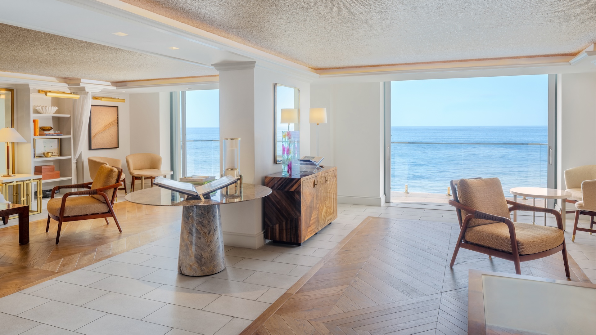a room with a table and chairs and a large window