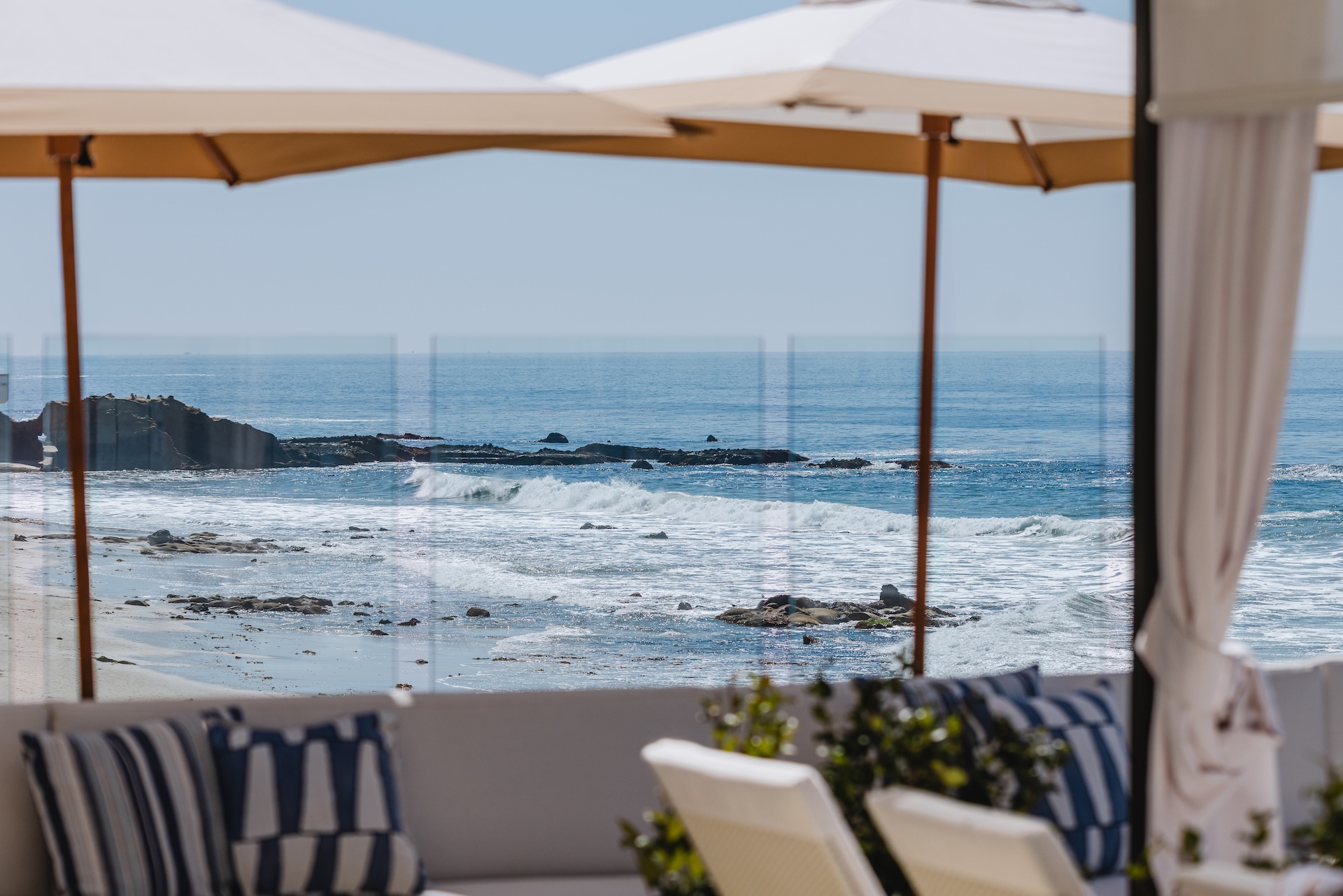 a beach with umbrellas and chairs