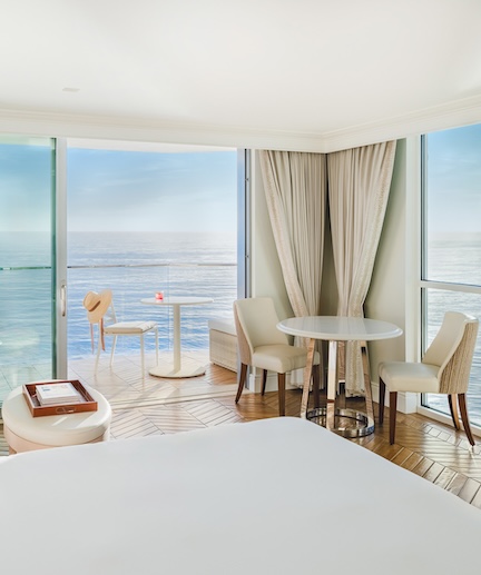 a room with a bed and chairs and a table