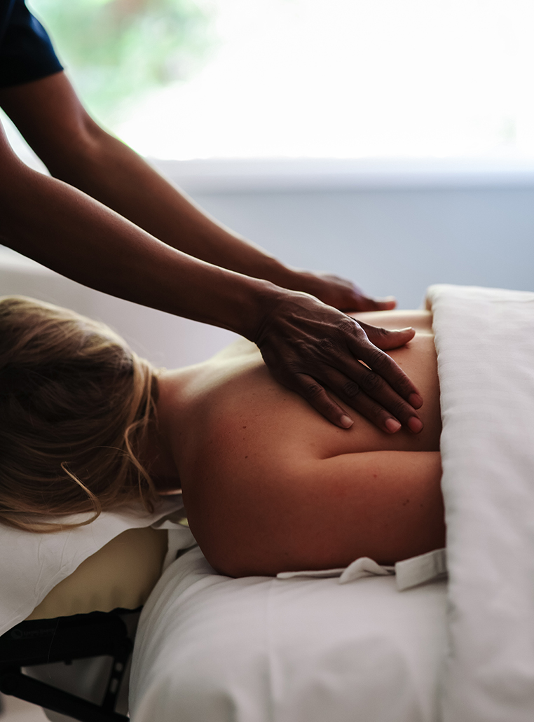 a person's hand on a woman's back