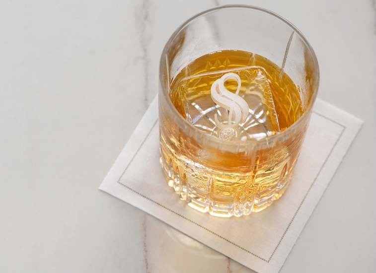 a glass with a drink and ice cubes