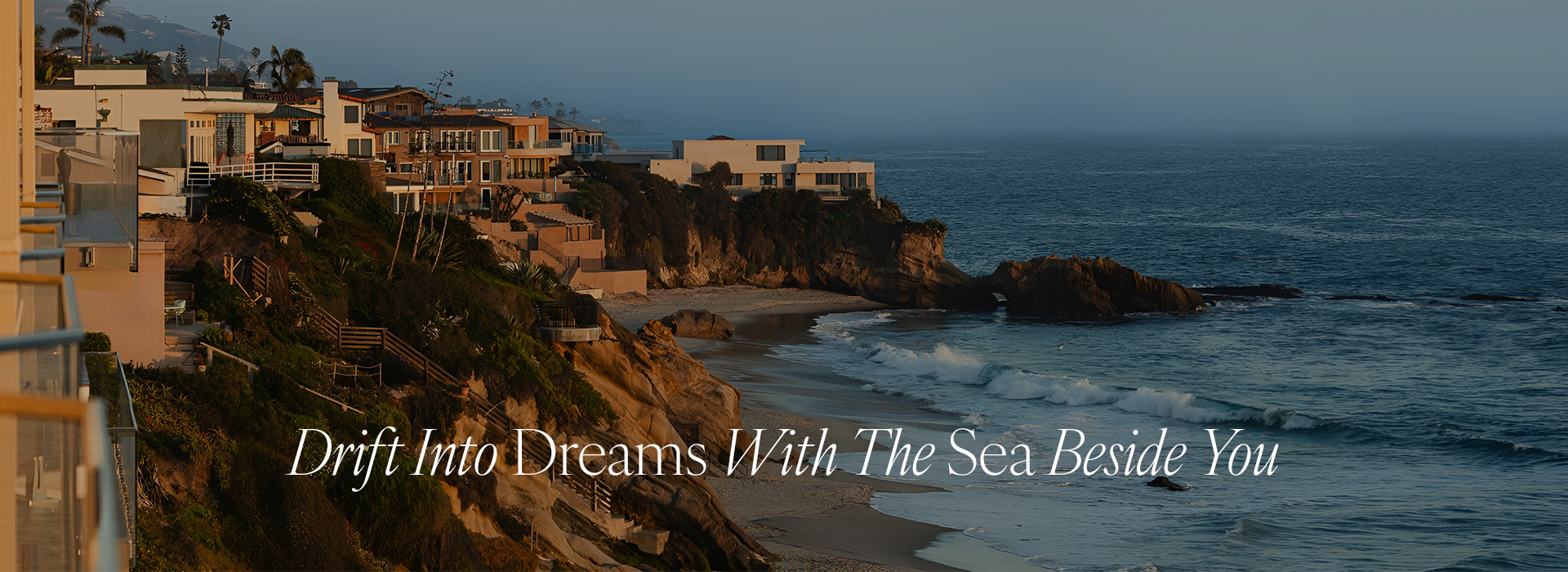 a beach with houses and a body of water