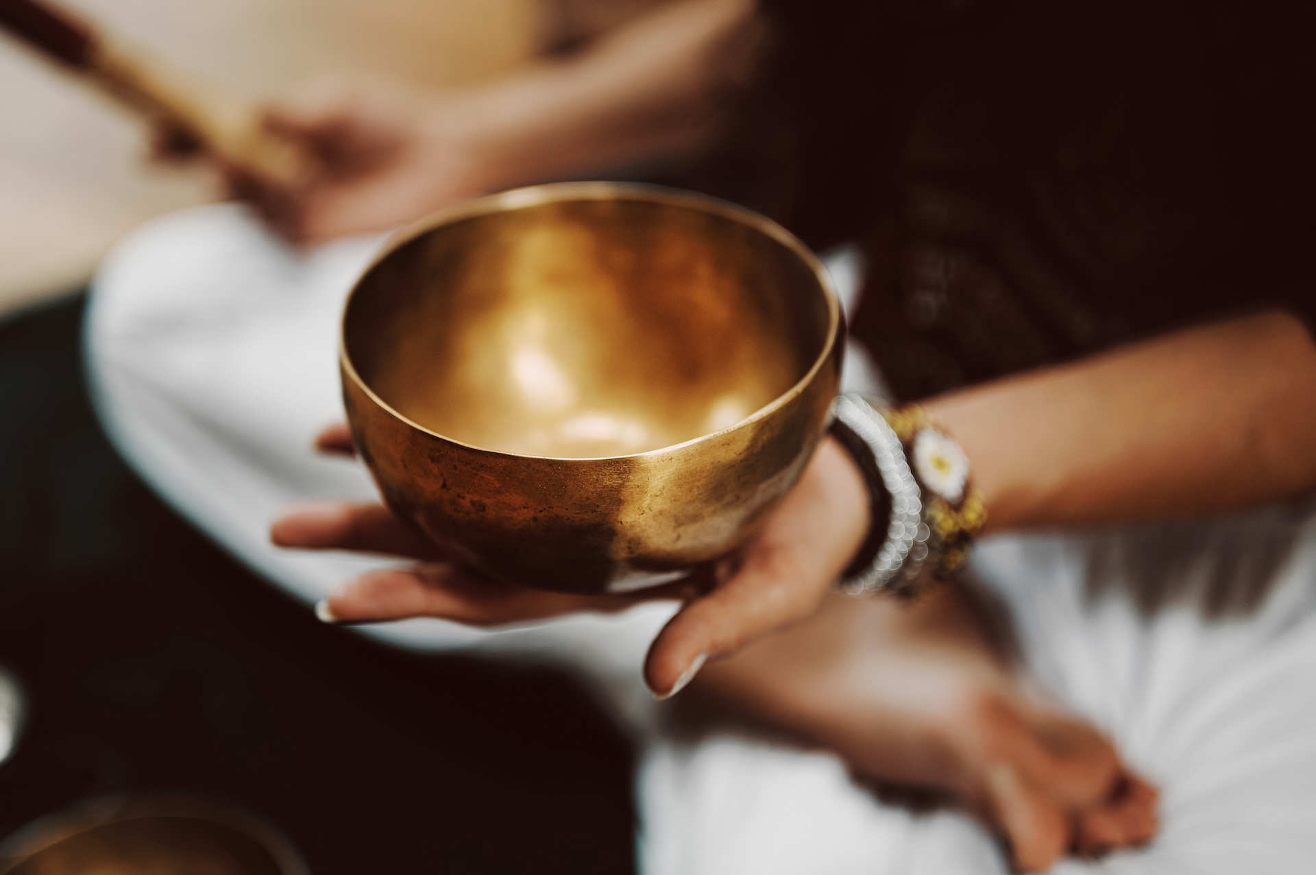 a person holding a gold bowl