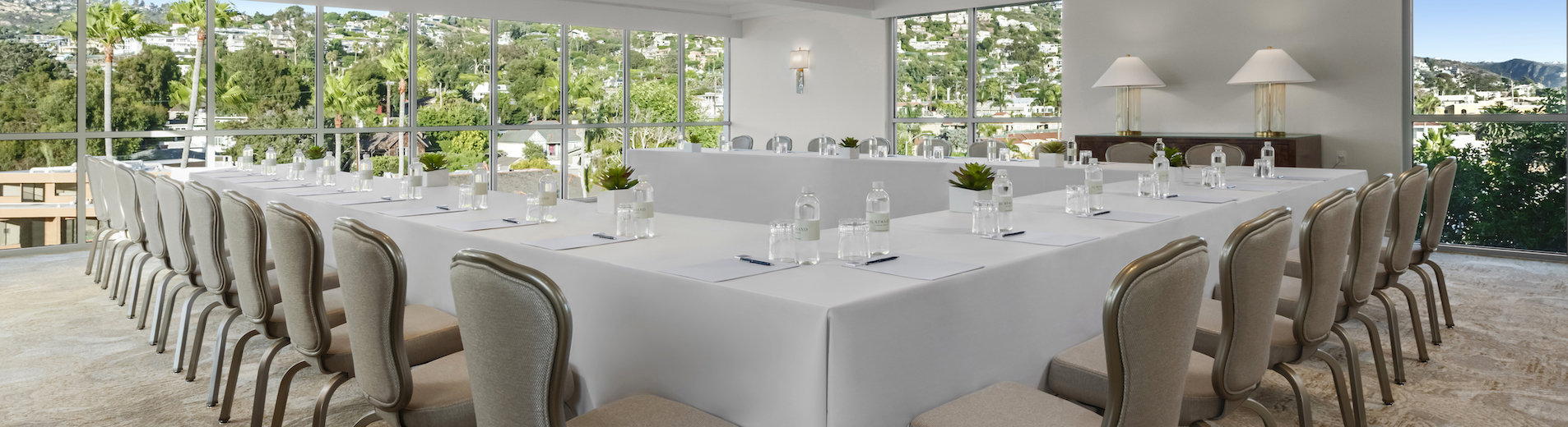 a white table with white tablecloths and water bottles on it