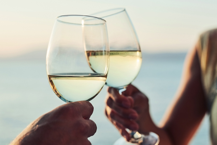 two people toasting with wine glasses