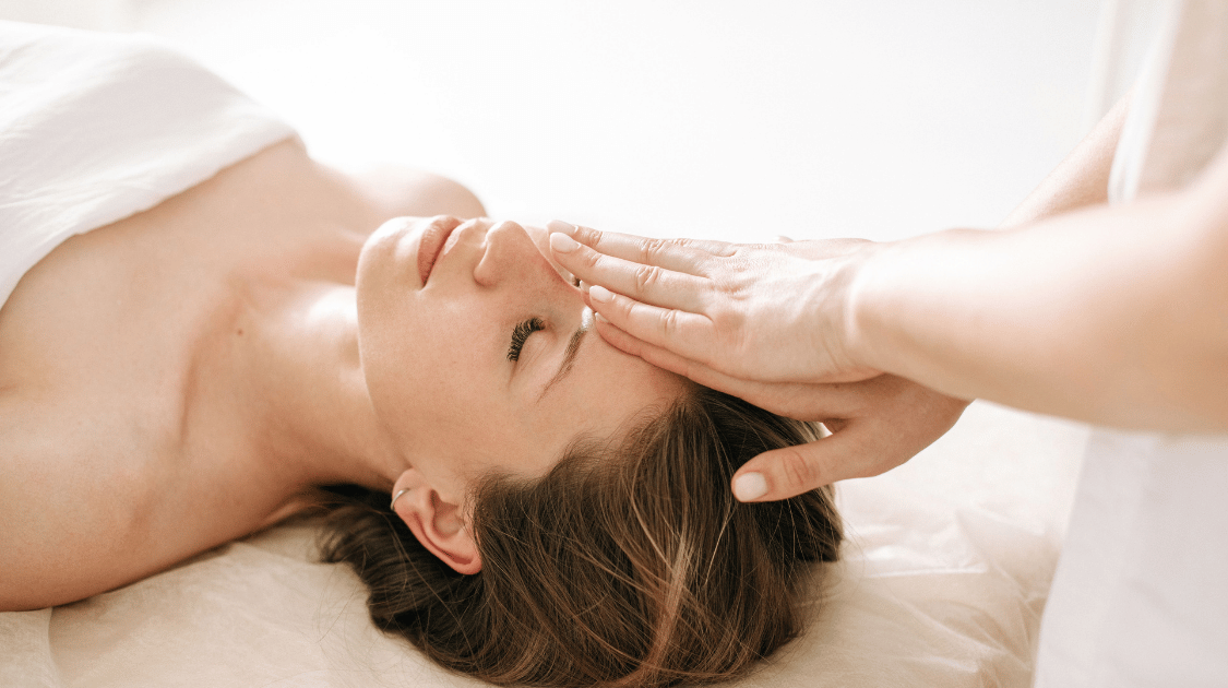 a woman lying down with her hand over her face