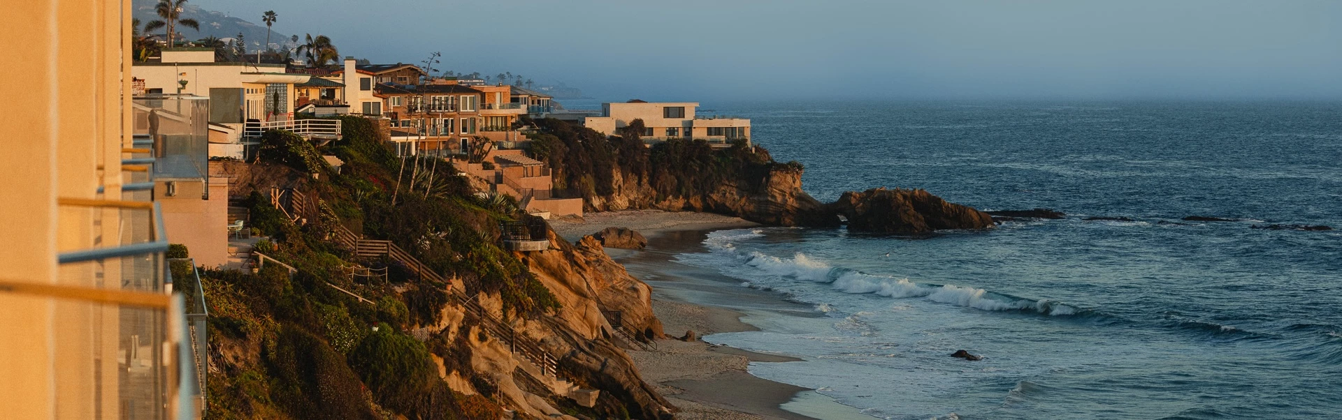 a beach with houses and a body of water