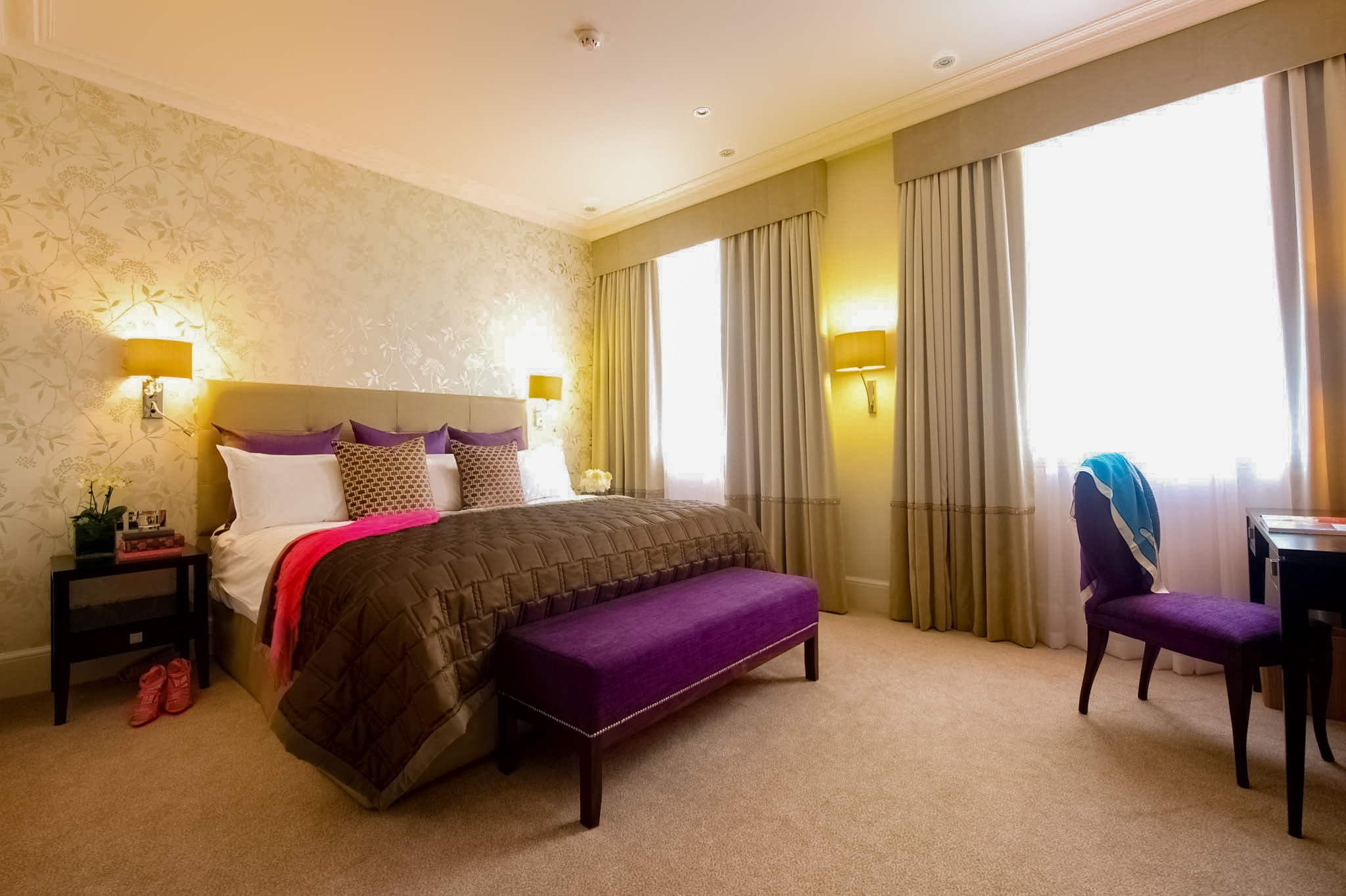 a bedroom with a bed and a chair