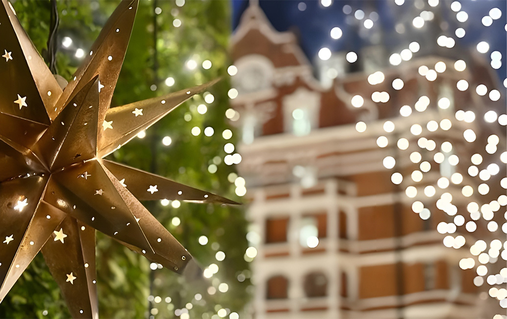 a star shaped christmas decoration in front of a building