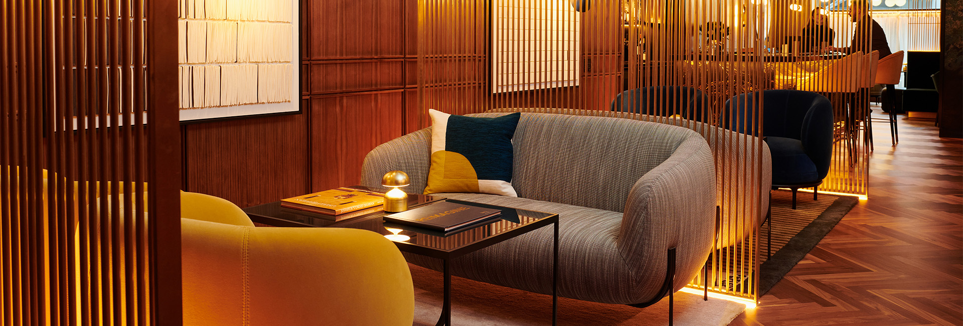 a couch with a glass table and a lamp