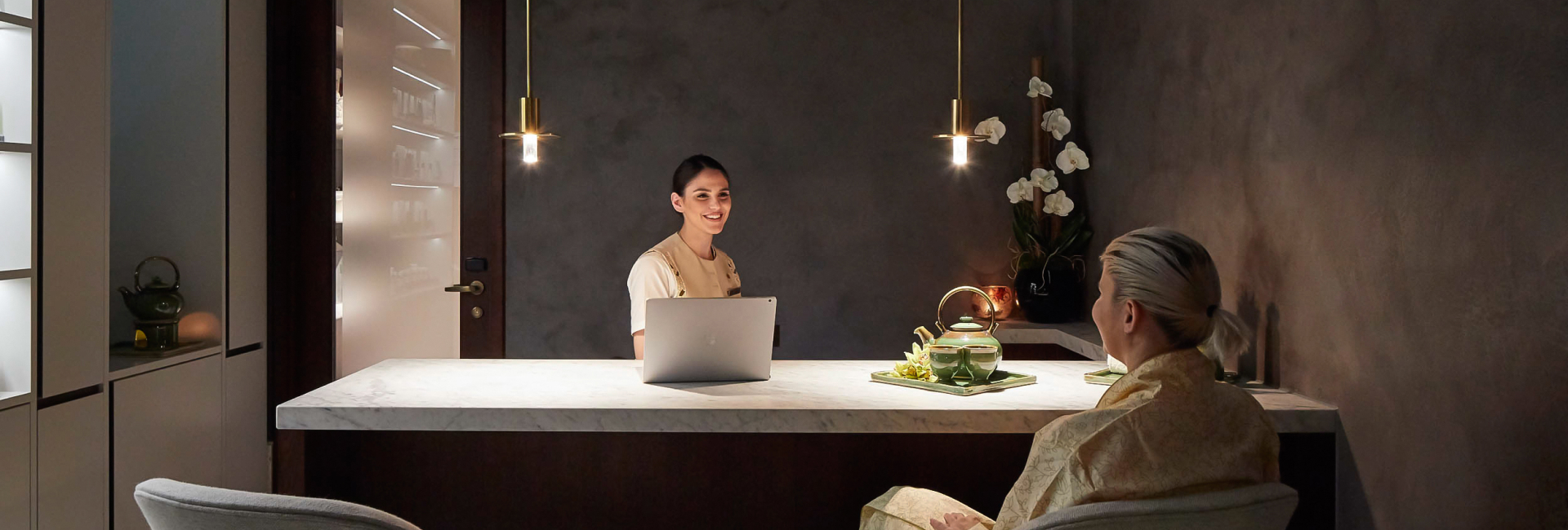 a woman sitting at a counter with a laptop