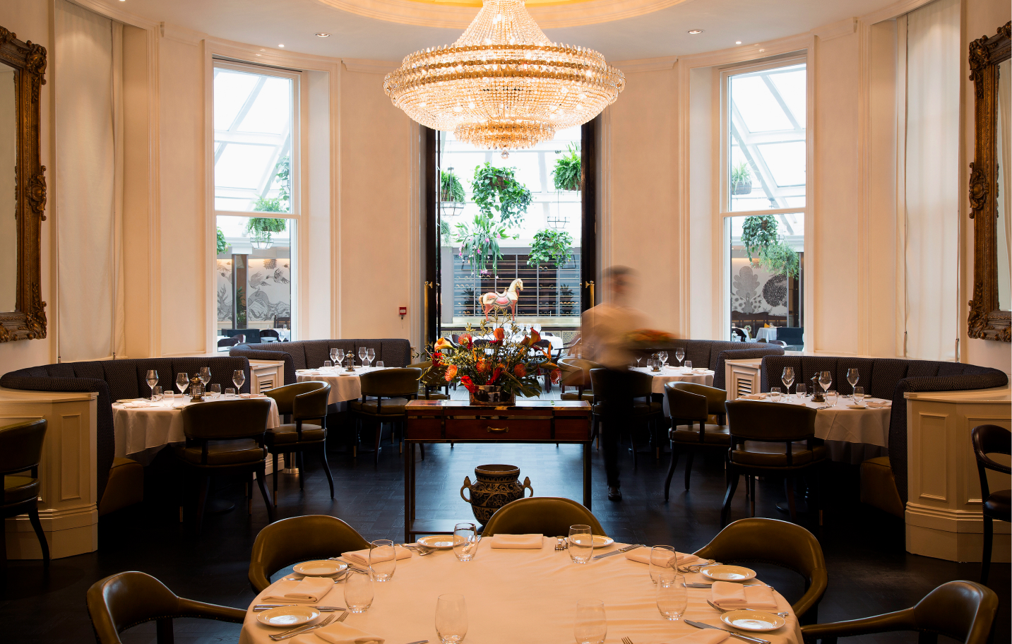a room with tables and chairs and a chandelier