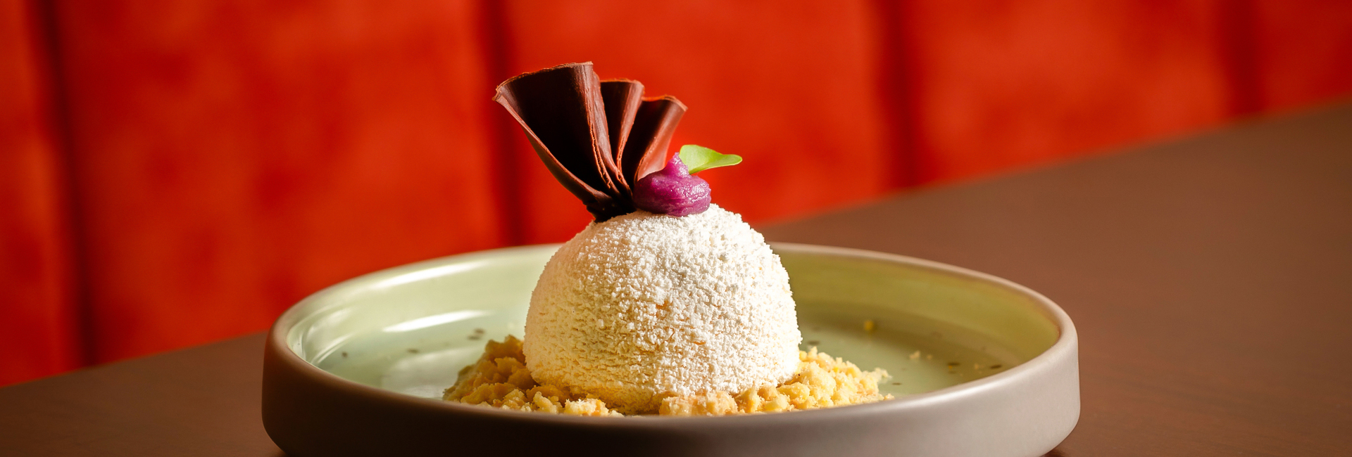 a white ice cream with a chocolate garnish on top of it