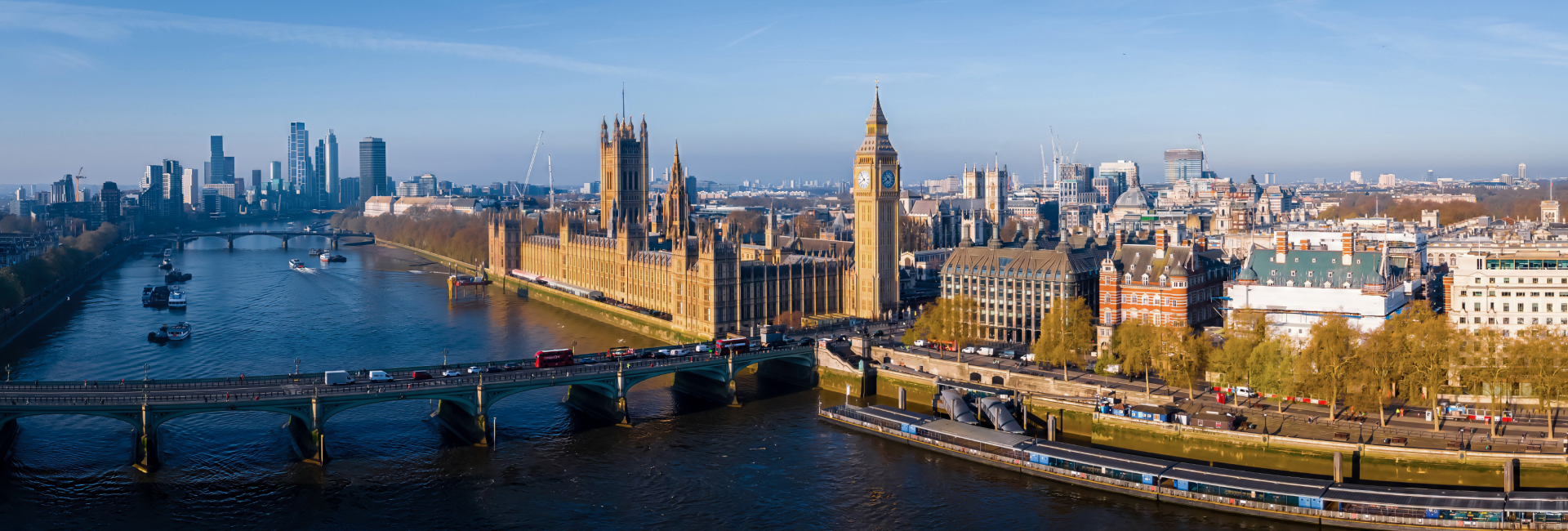 a bridge over a river with a clock tower in the middle