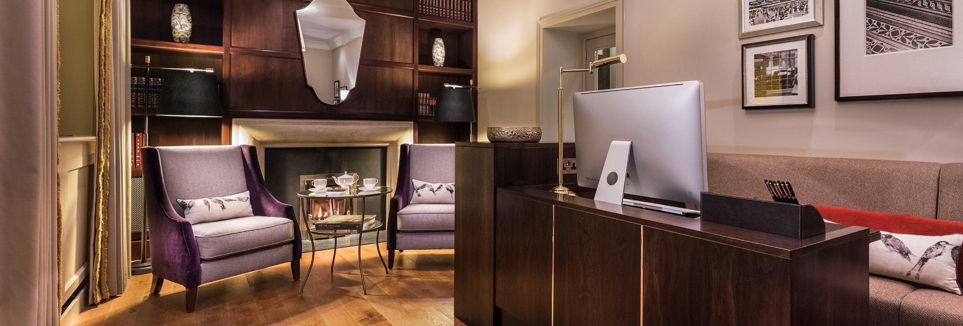 a room with a fireplace and a computer