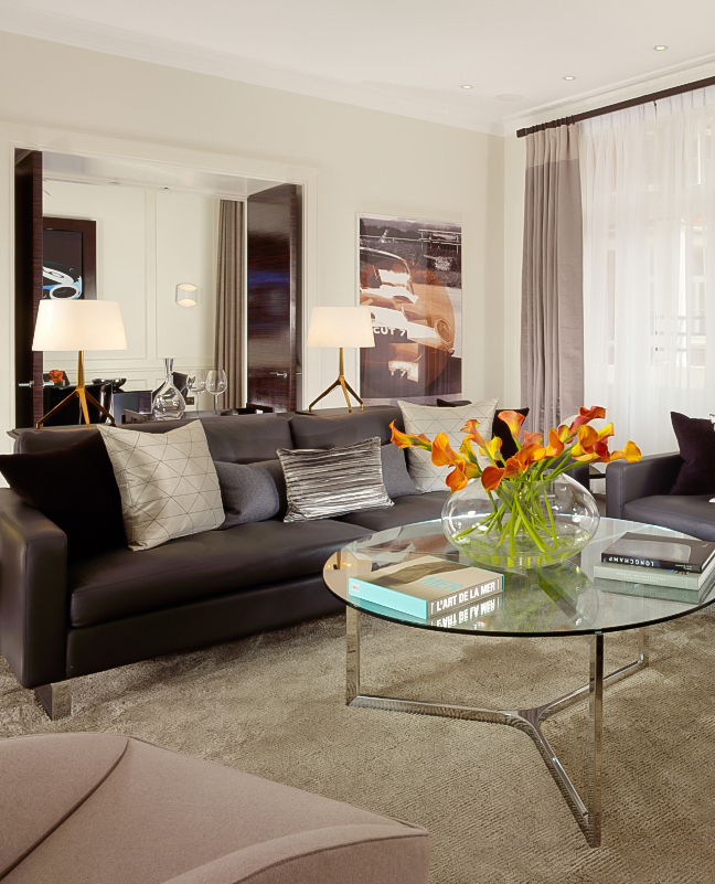 a living room with a couch and a glass coffee table