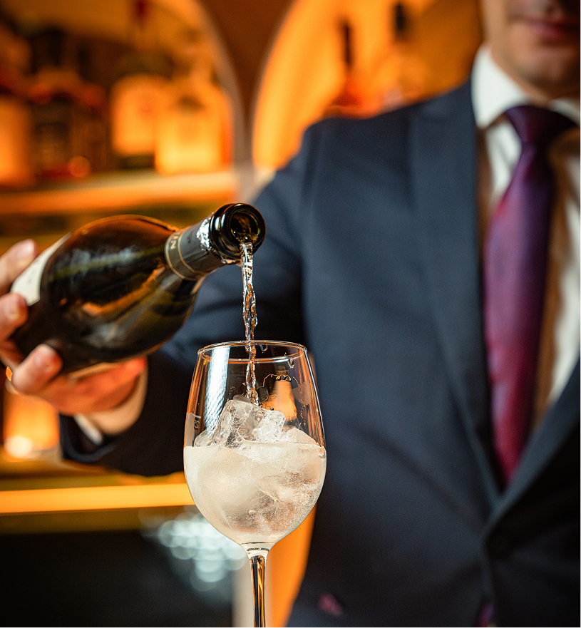 a man pouring a wine into a glass
