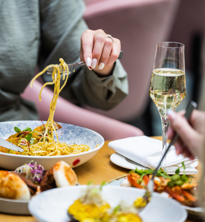 a person eating food with a fork and knife