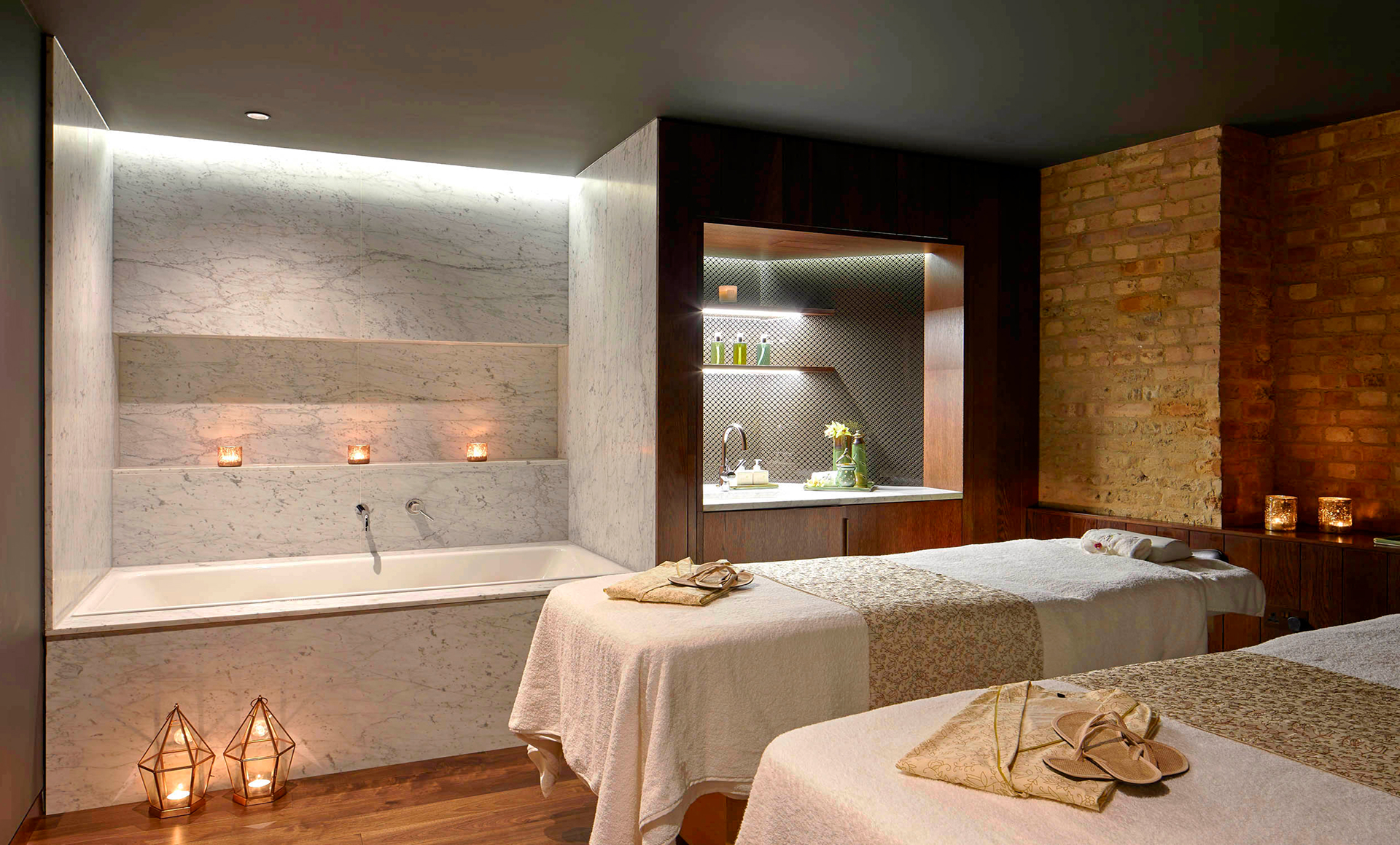 a room with a bathtub and massage tables
