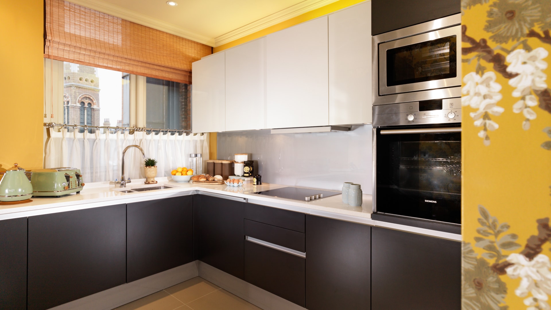 a kitchen with black cabinets and white cabinets