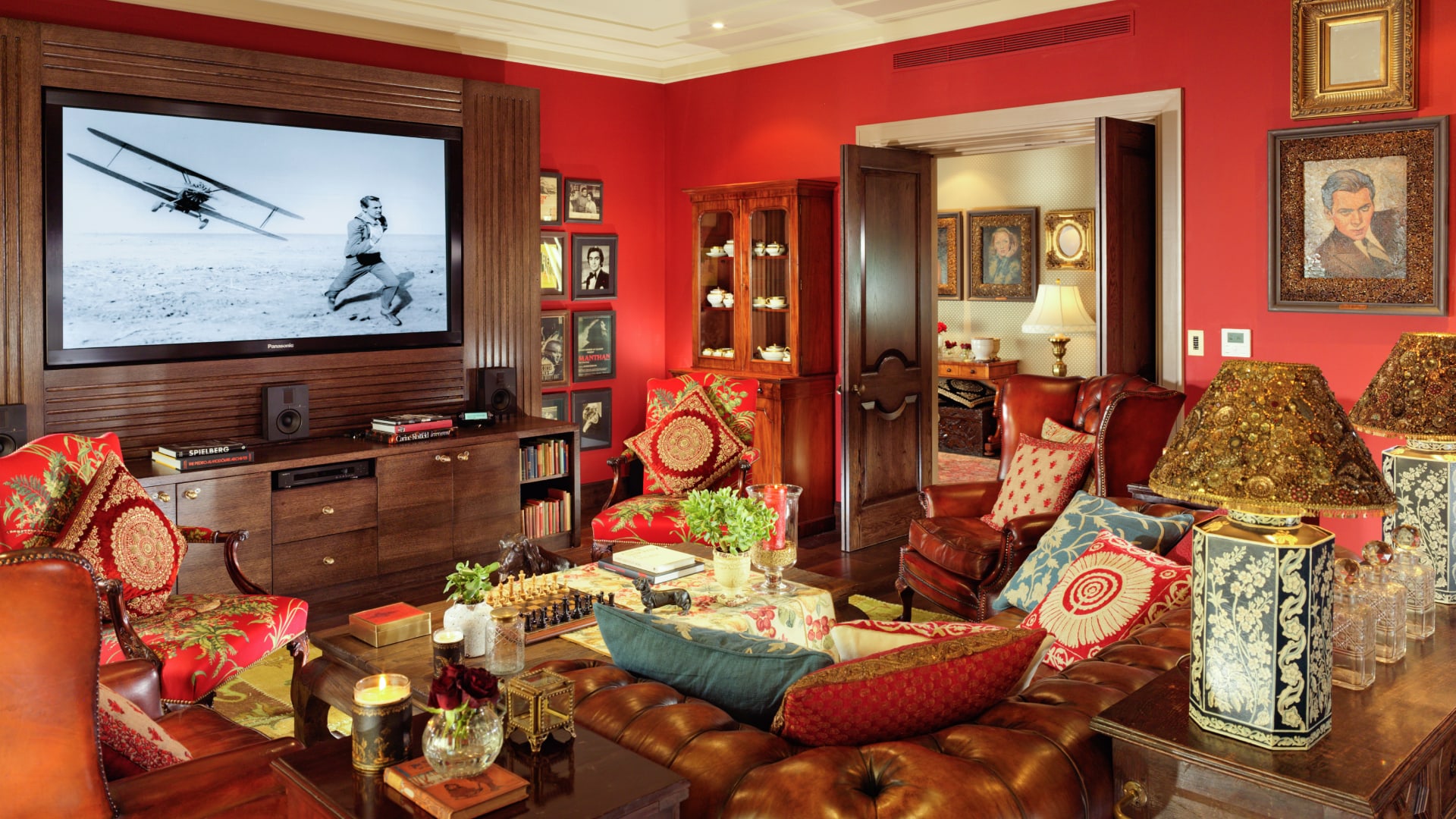 a living room with red walls and a television
