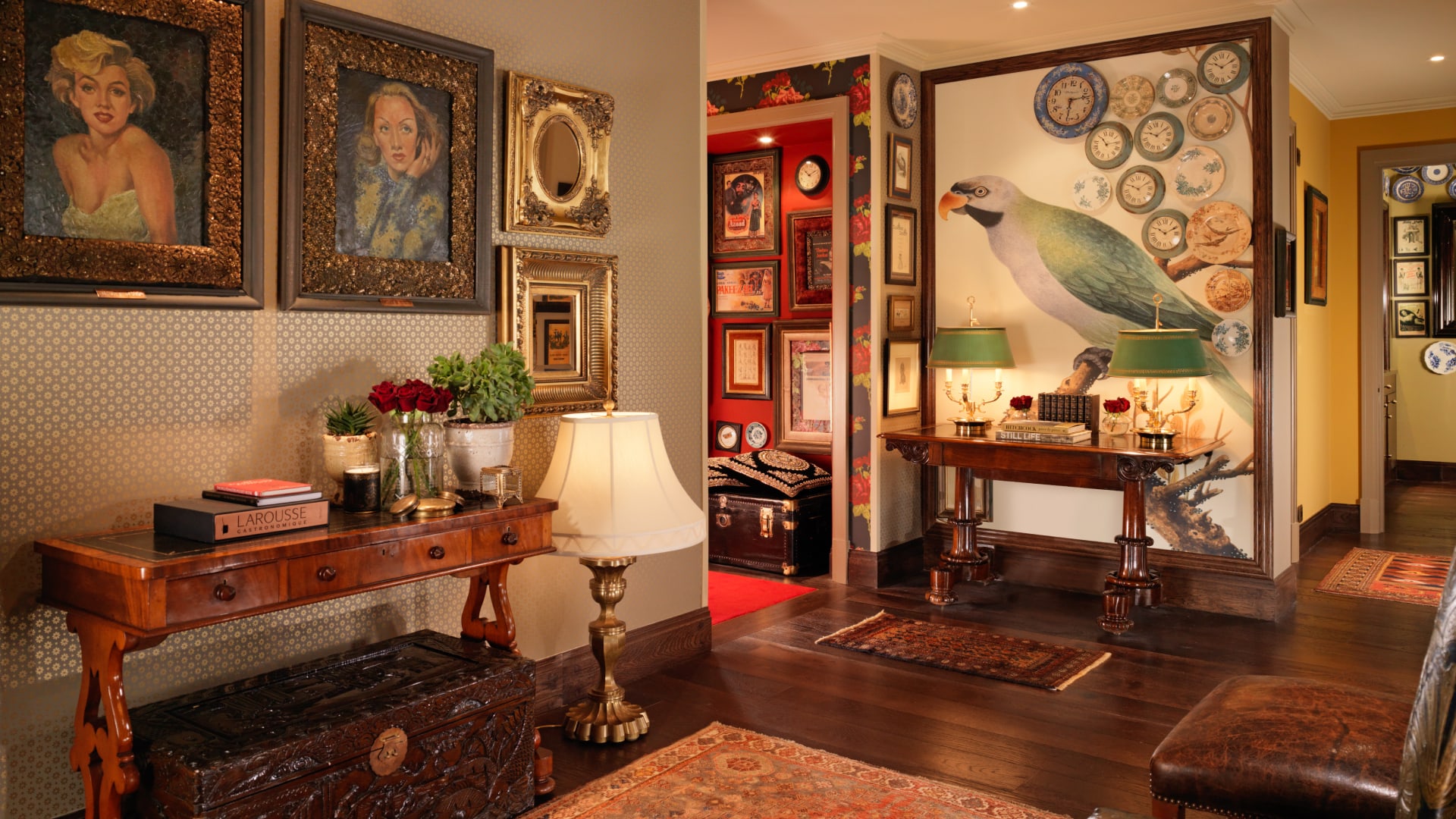 a room with a table lamp and pictures on the wall