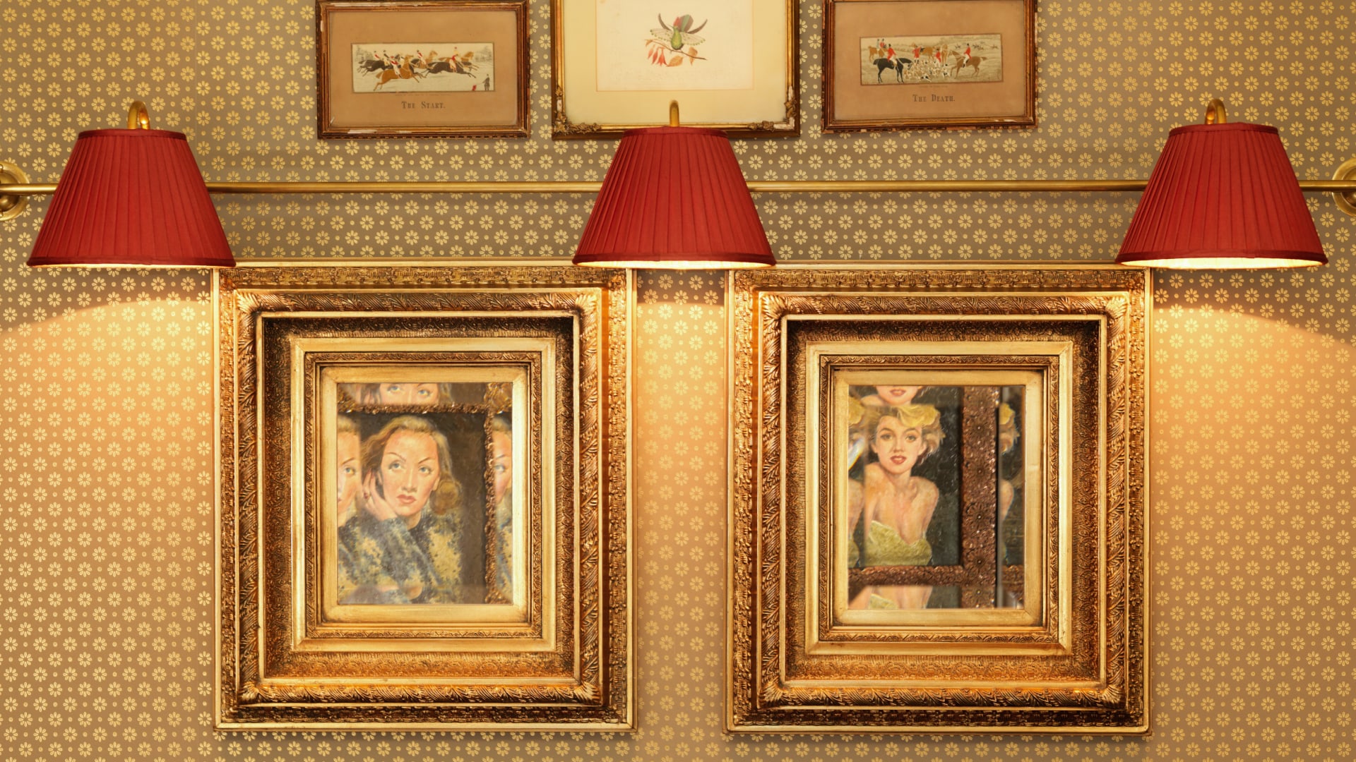 a group of framed pictures on a wall