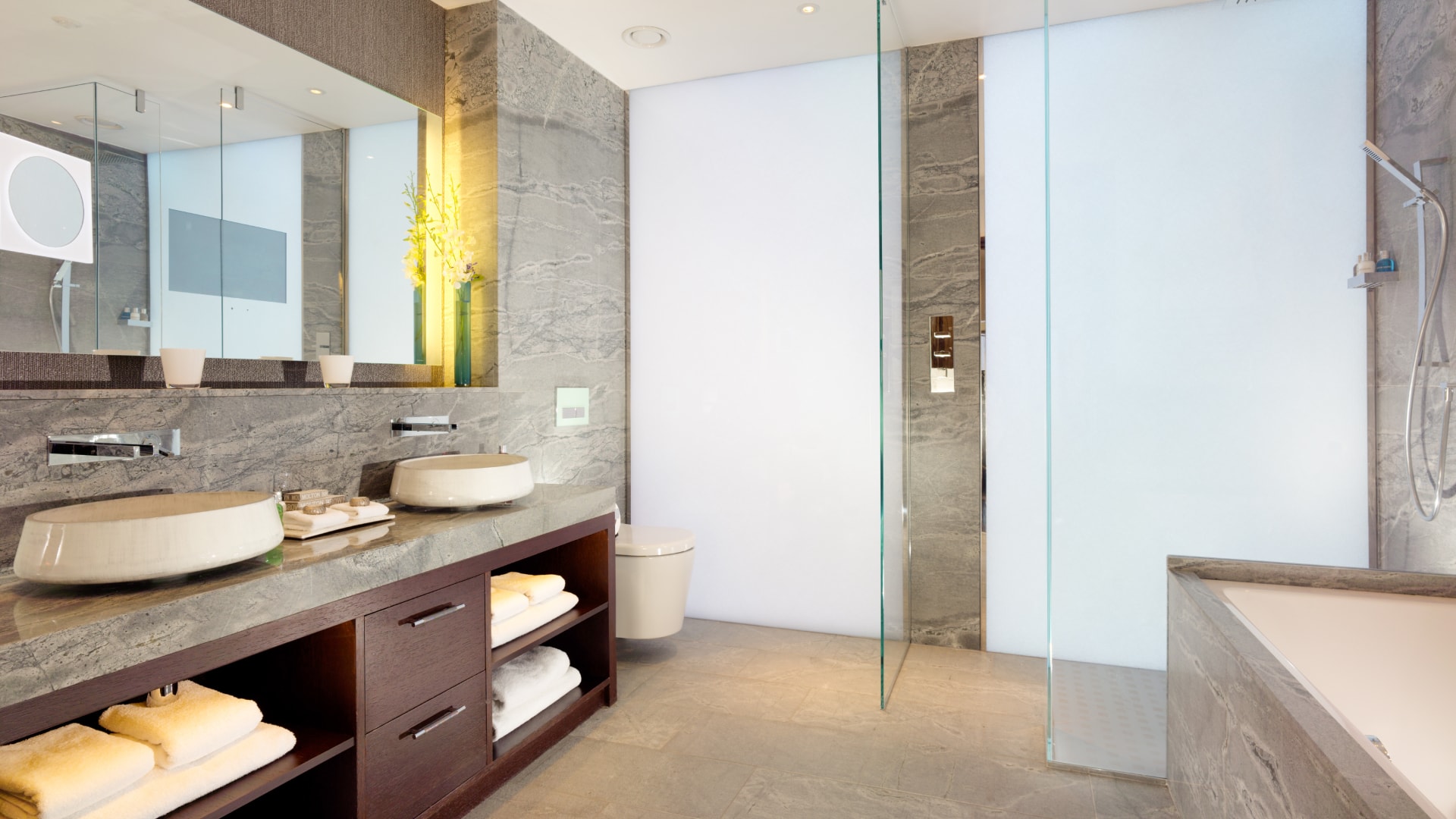 a bathroom with a glass shower and sink