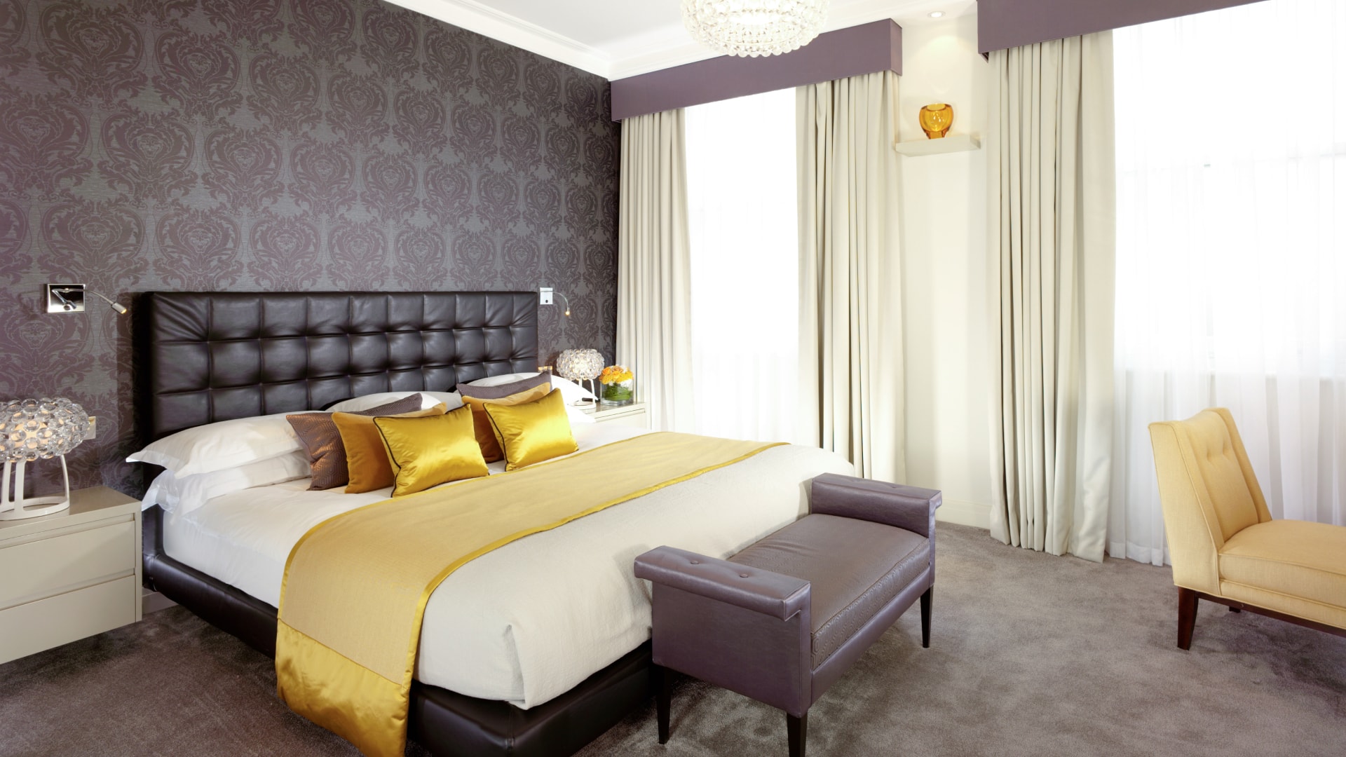 a bedroom with a bed and a chair