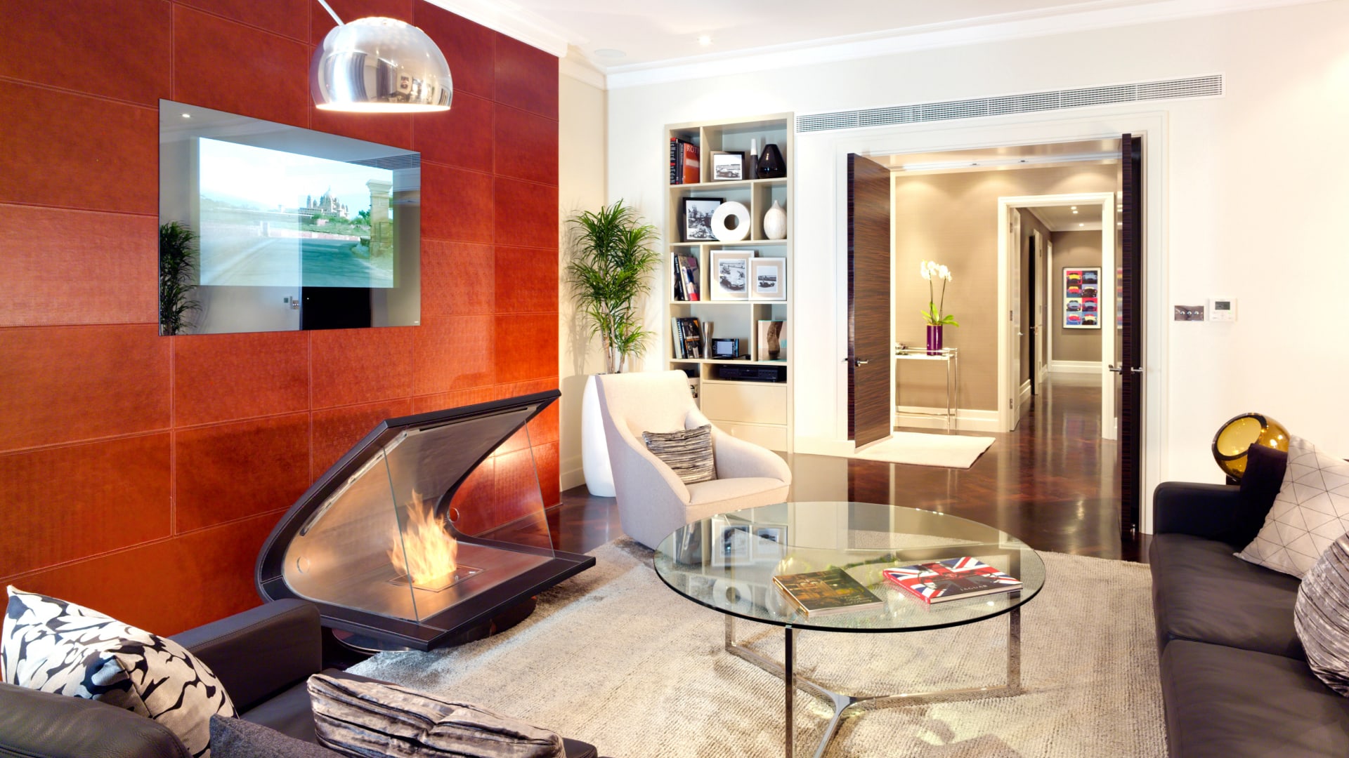 a living room with a fireplace and a glass table