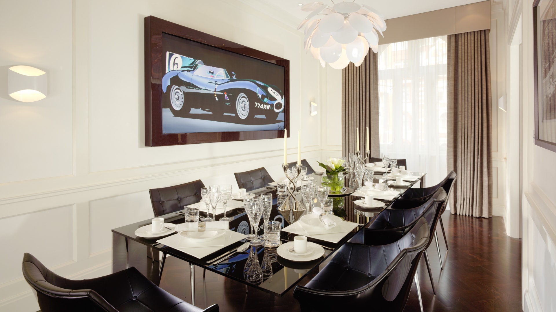 a dining room with a large picture of a race car