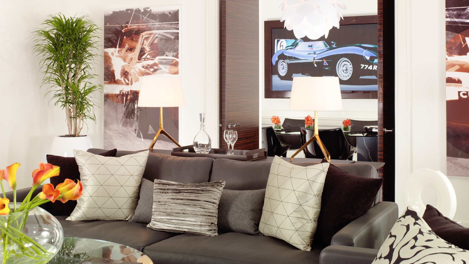 a couch with pillows and lamps in a room