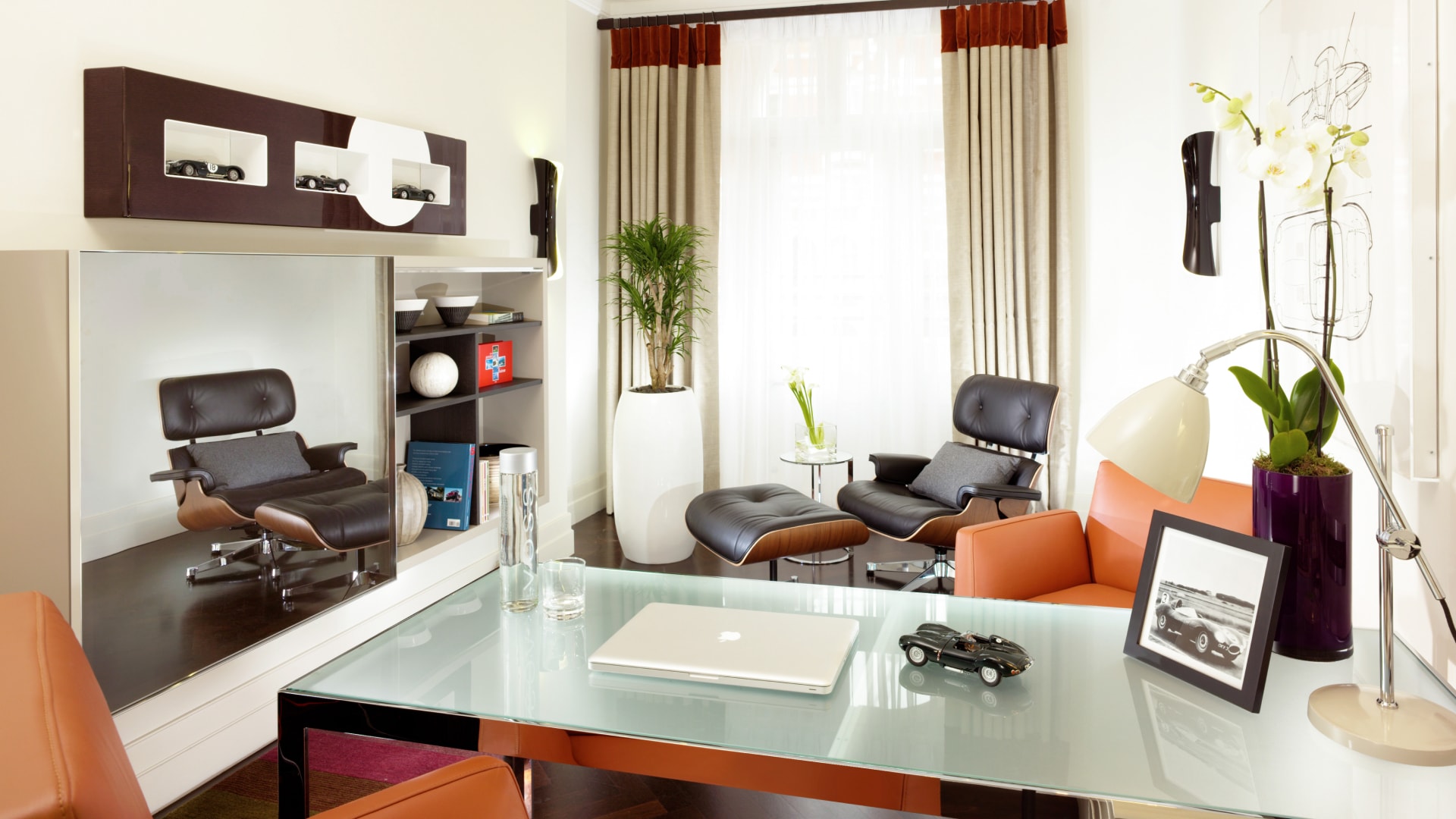 a room with a glass table and chairs