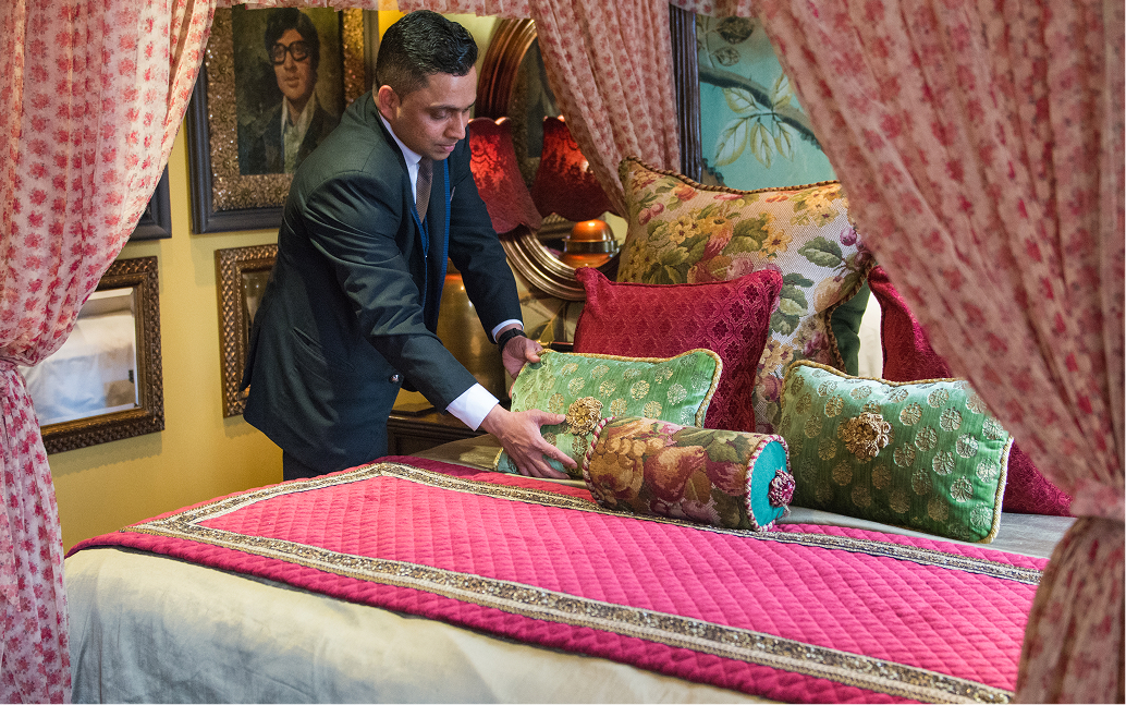 a man in a suit arranging pillows
