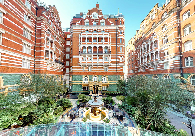 a courtyard with a fountain in front of a building