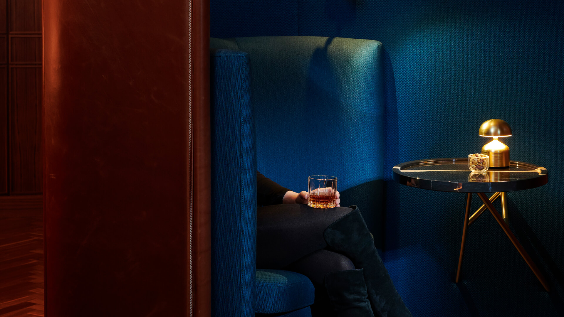 a person holding a glass of alcohol