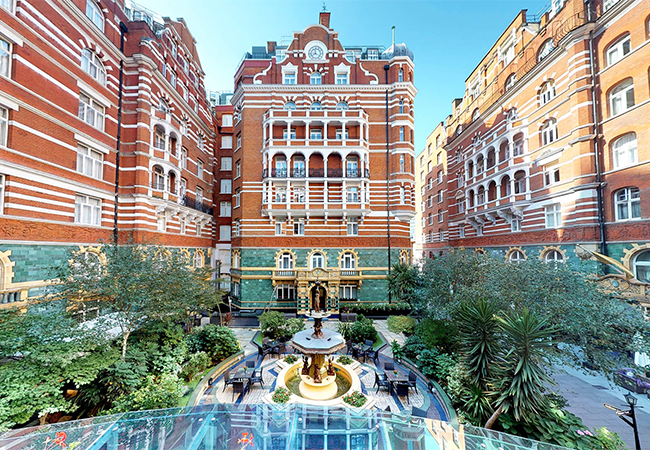 a courtyard with a fountain in front of a building