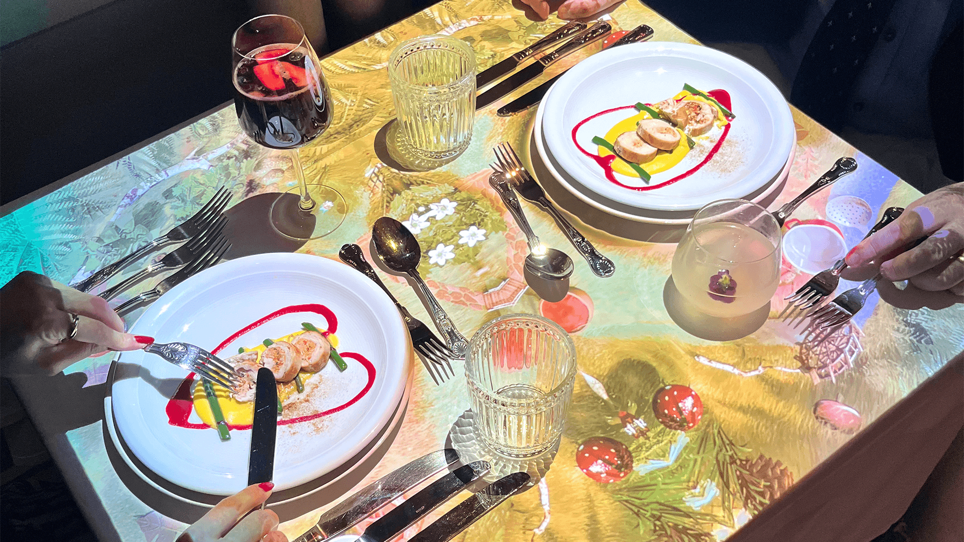 a table with plates and glasses and cutlery