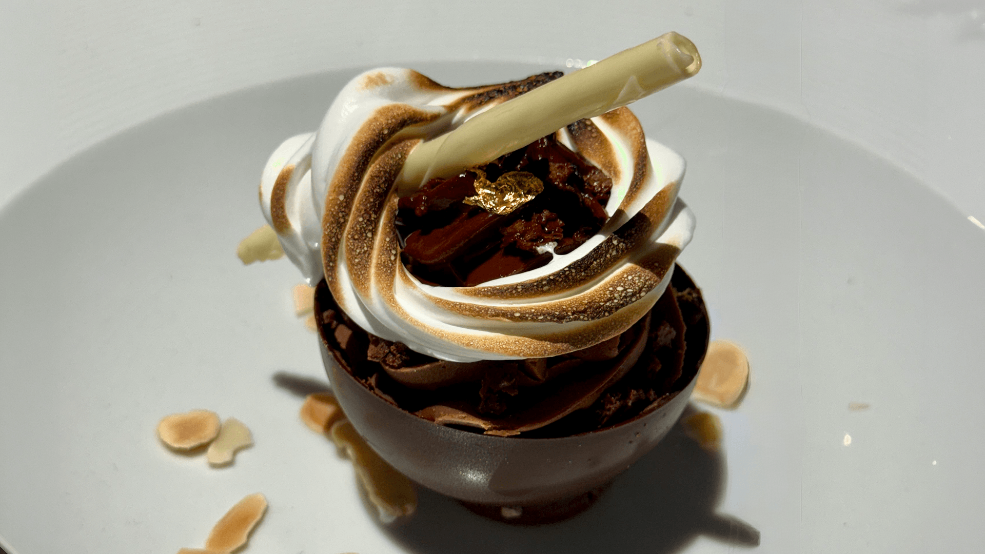 a chocolate dessert with a straw on top