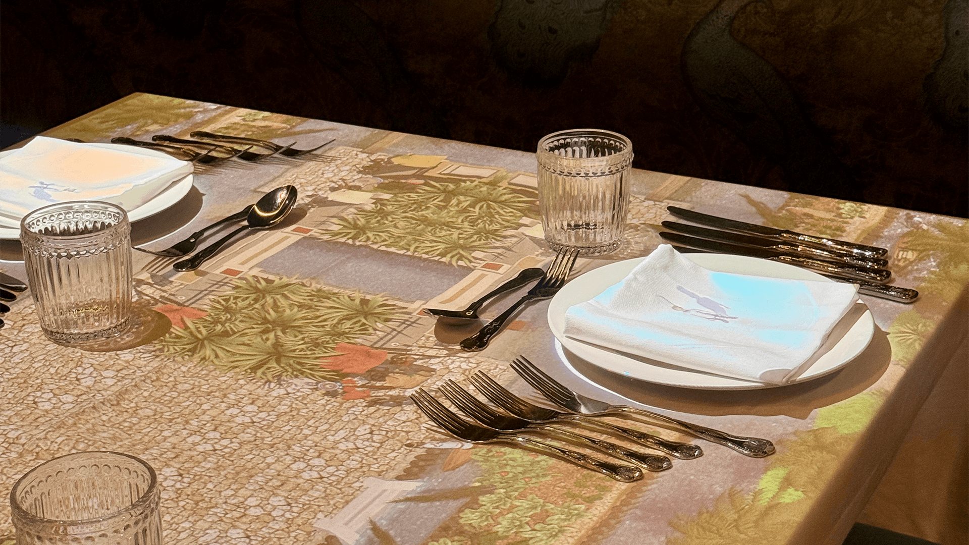 a table with silverware and a plate on it