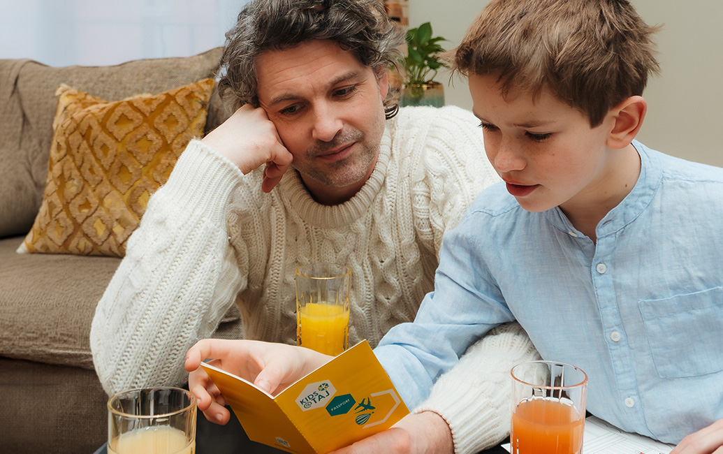 a man and boy looking at a book